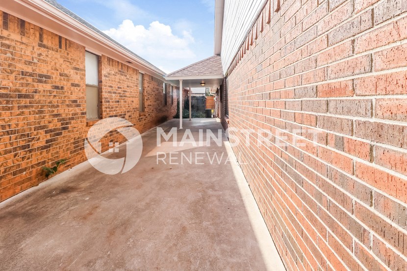 a walkway between two brick walls of a building