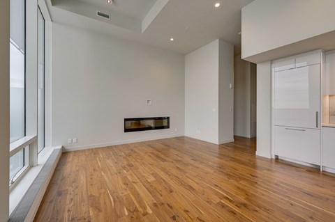 A room with wooden floors and a fireplace.