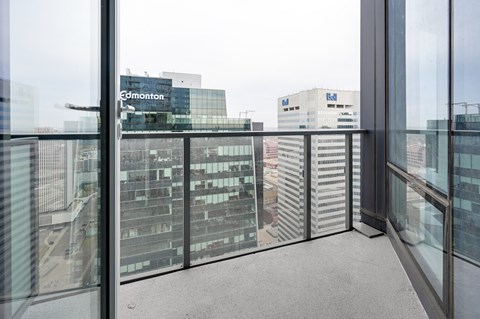 A view from a window of a cityscape with buildings and a sign that says Edmonton.