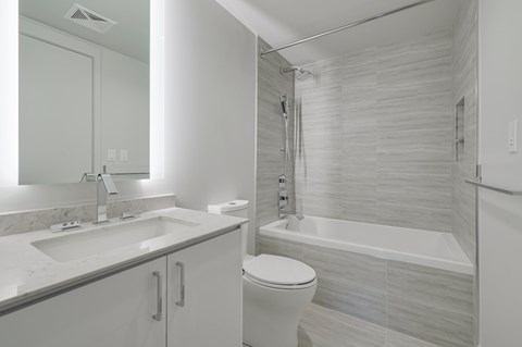 A white bathroom with a sink, toilet, and bathtub.