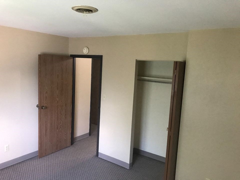 a room with a closet and two doors