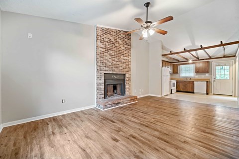 A room with a fireplace and a ceiling fan.