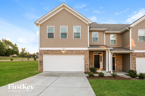 A two-story house with a garage is for sale.