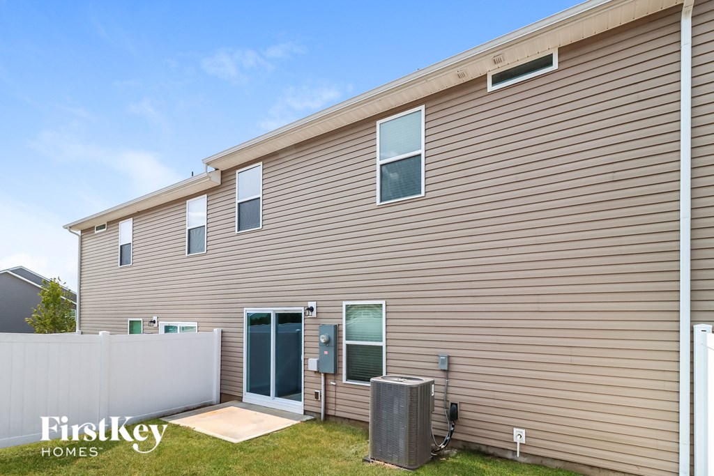 the exterior of a home with brown siding and a backdoor