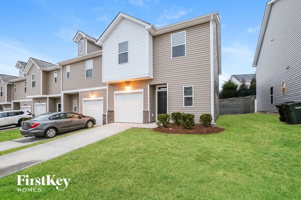 A modern house with a garage is showcased in the image.