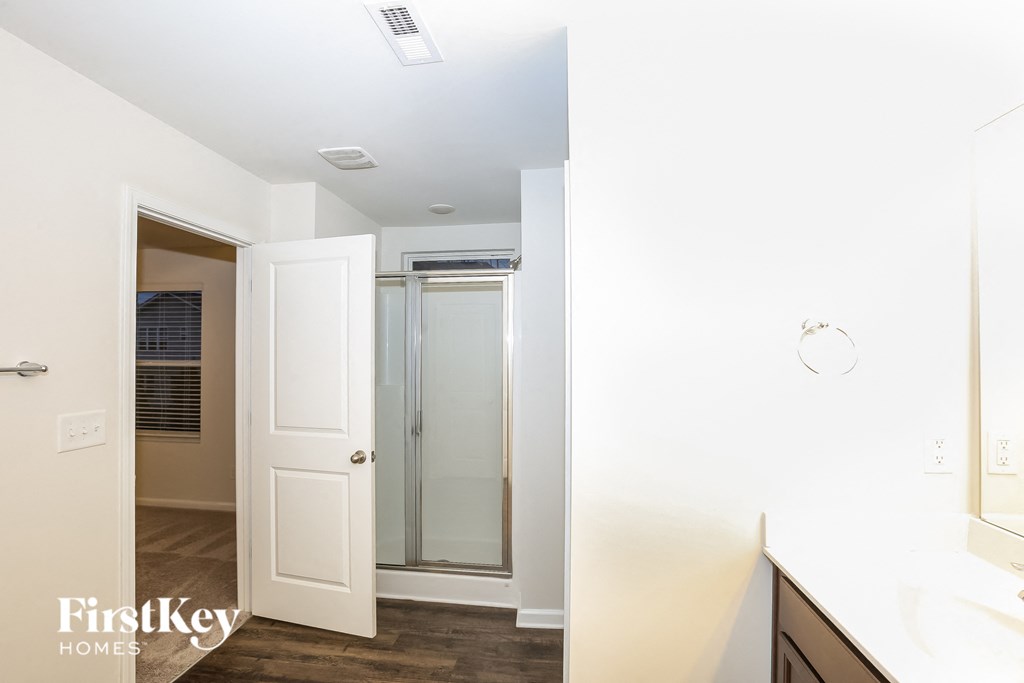 A white door is open to a hallway.