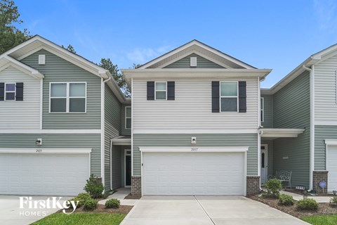 A row of houses with the number 2017 on the front.