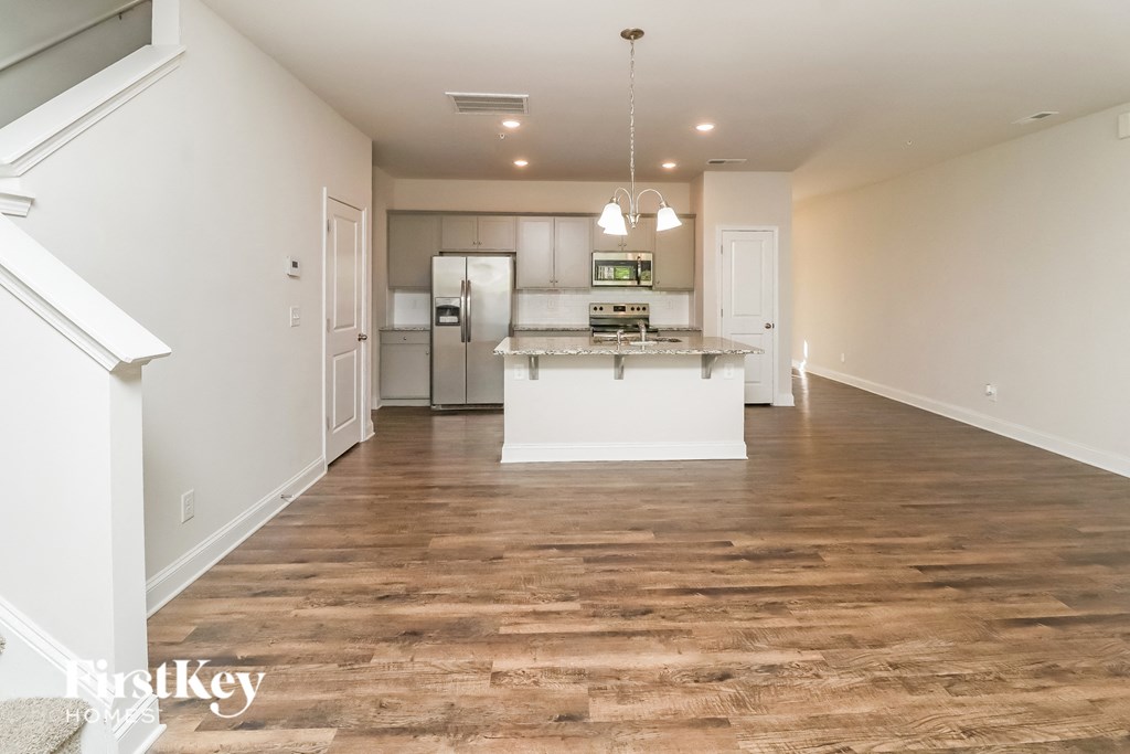 A kitchen with a refrigerator, stove, and oven.