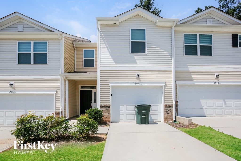 A row of houses with the first key homes logo on the front of the first house.