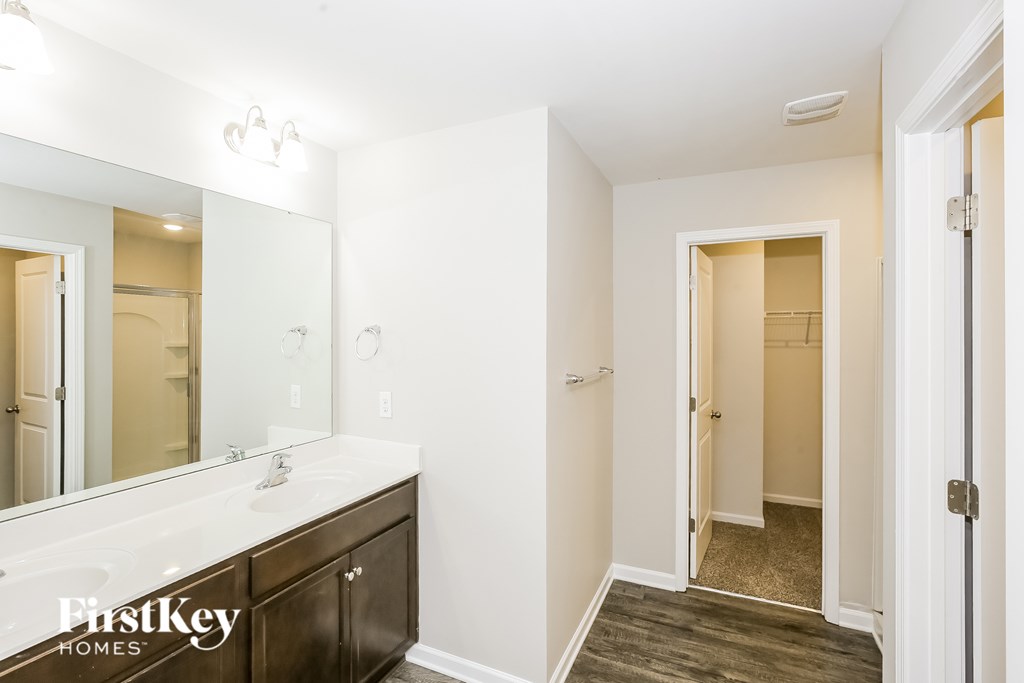 A bathroom with a white sink and a mirror.