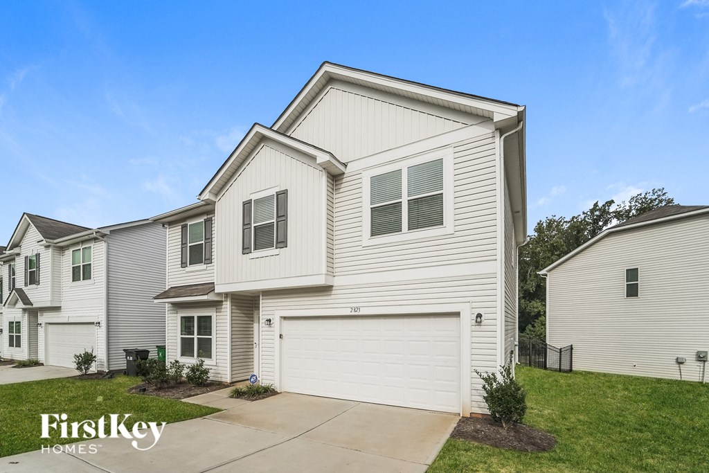 a white house with a white garage door