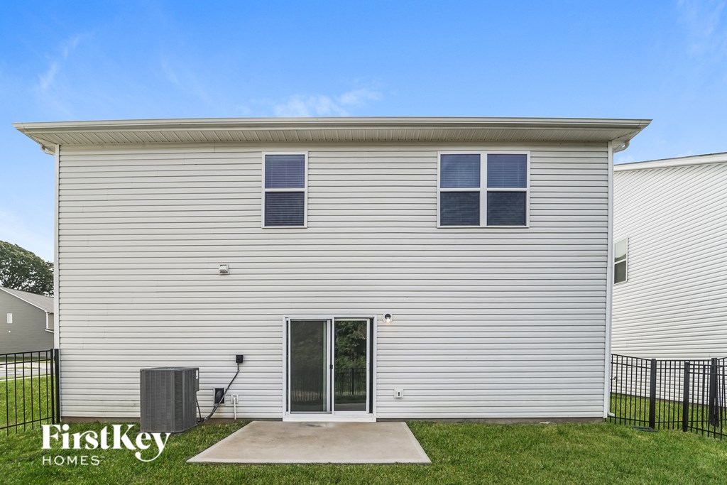 the exterior of a home with white siding and grass