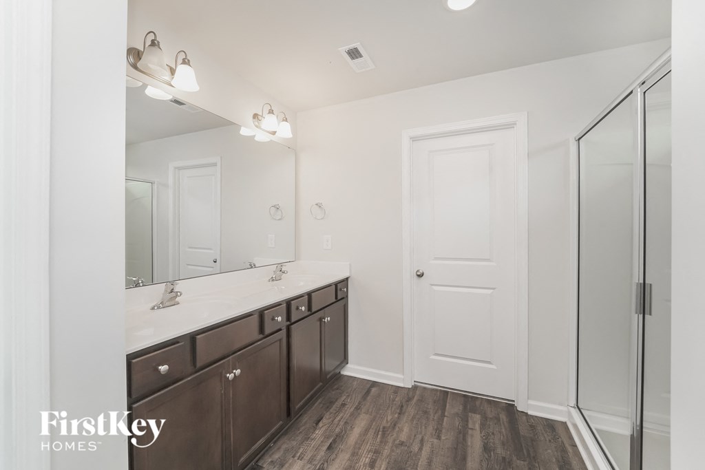 a bathroom with a mirror and a sink and a shower