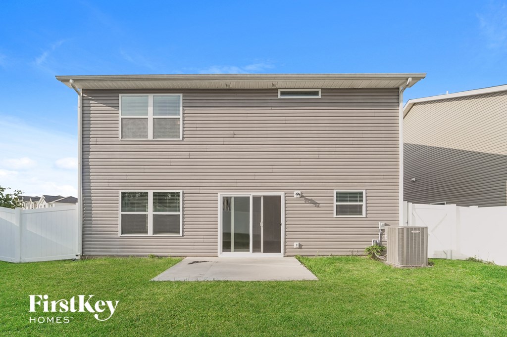 the front of a house with a yard and grass