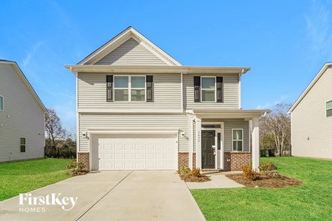 a beige house with a white garage door