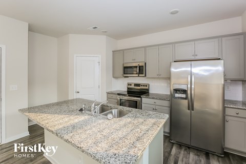 A kitchen with granite countertops and stainless steel appliances.