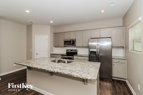 A kitchen with granite countertops and stainless steel appliances.