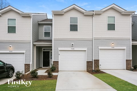 a white house with two garage doors