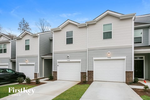 a white house with two garage doors