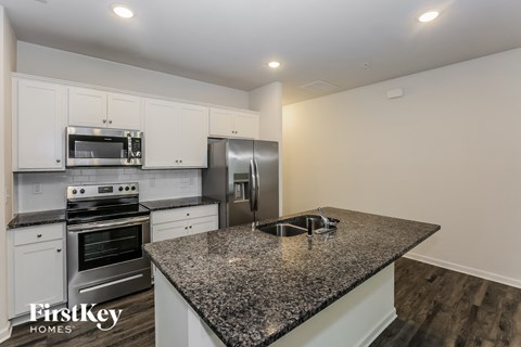 a kitchen with granite counter tops and stainless steel appliances