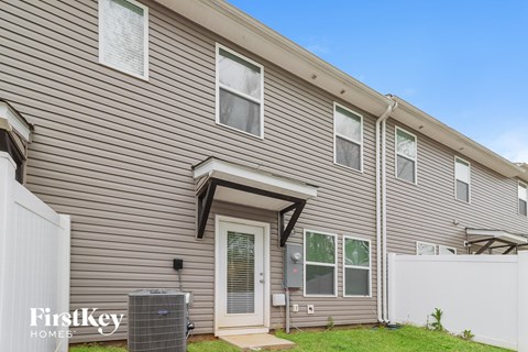 A FirstKey Homes sign is displayed on a residential building.