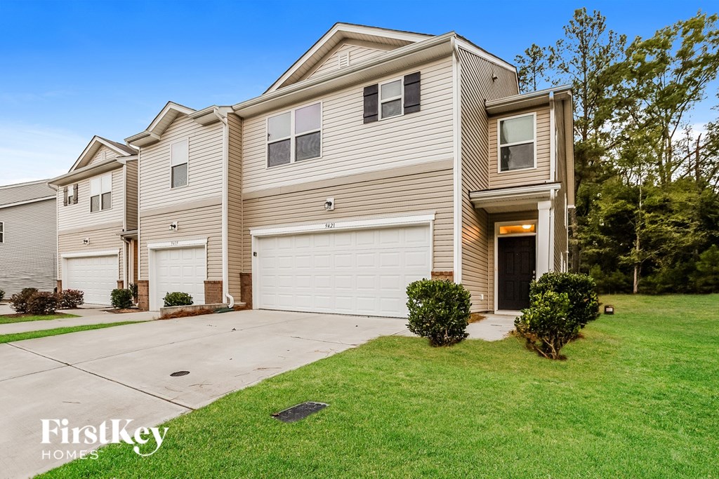 A row of houses with the logo "FirstKey Homes" on the bottom left.