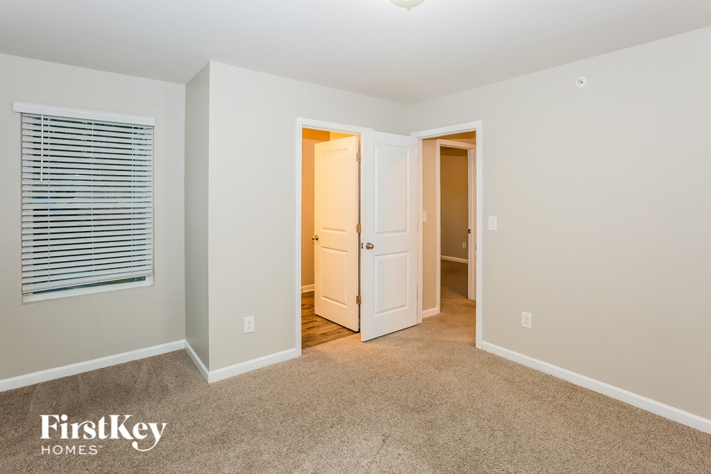 A room with a carpeted floor and a white ceiling with a light fixture.