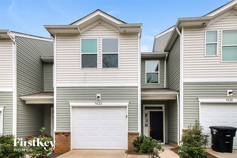 a white and gray house with a white garage door