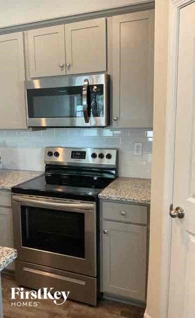a kitchen with a stove and a microwave