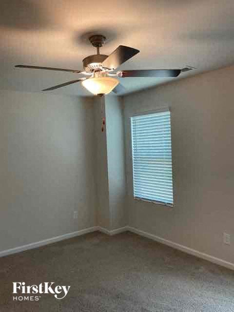 a bedroom with a ceiling fan and a window