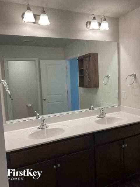 a bathroom with two sinks and a large mirror