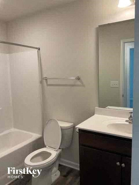 a white bathroom with a toilet and a sink