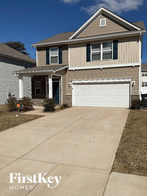 a driveway in front of a house with a garage door