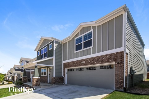 A modern house with a garage is showcased in the image.