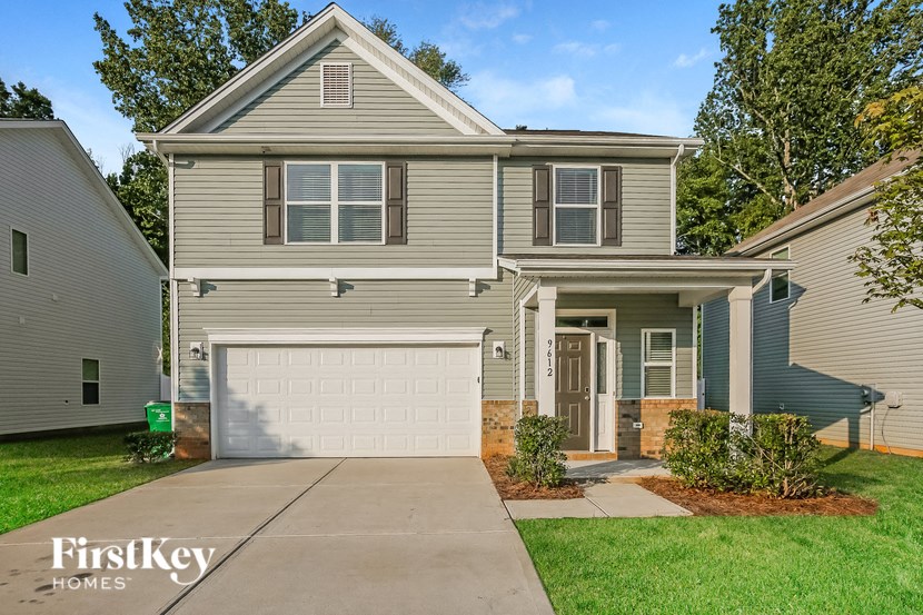 a beige house with a white garage door