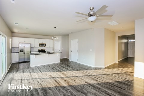 A spacious kitchen with a refrigerator, microwave, and oven.