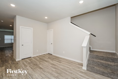 A room with a staircase and two doors.
