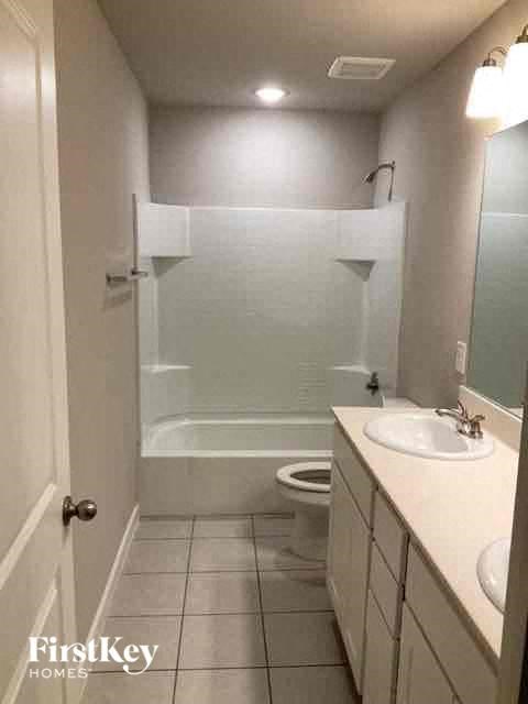 a bathroom with a sink and a toilet and a shower