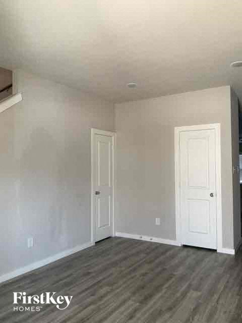 an empty room with a door and a white door