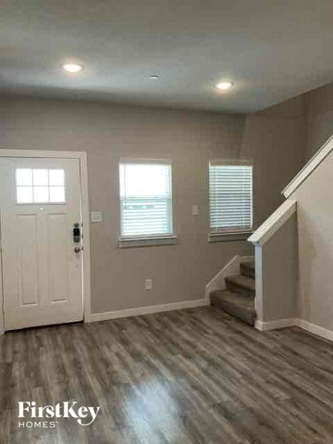 an empty house with a white door and stairs