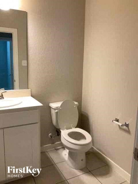a bathroom with a toilet and a sink and a mirror