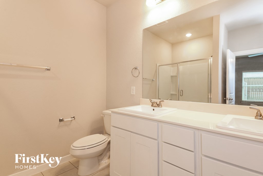 a bathroom with a toilet and a sink and a mirror