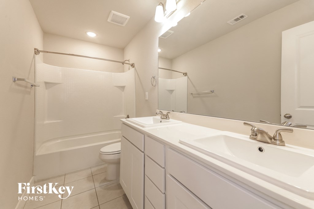 a bathroom with a sink and a shower and a toilet
