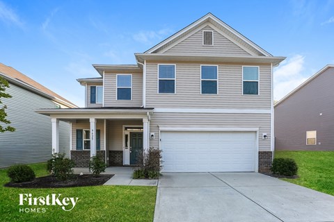 A two-story house with a garage is for sale by FirstKey Homes.