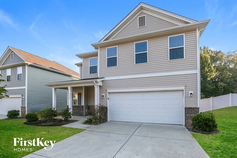 A two-story house with a garage is for sale by FirstKey Homes.