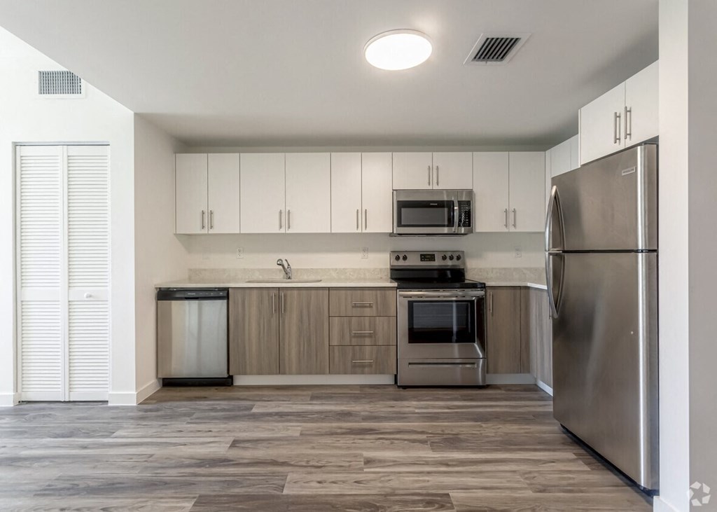 a kitchen with stainless steel appliances and white cabinets