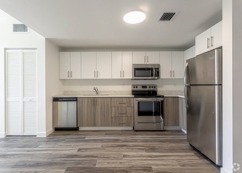 a kitchen with stainless steel appliances and white cabinets