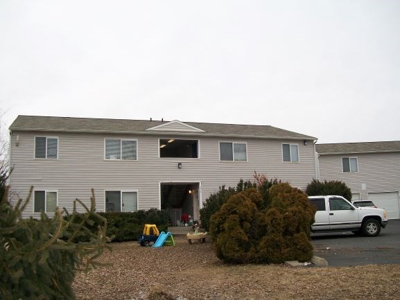 a house with a white truck parked in front of it