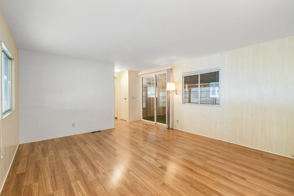 A room with wooden floors and white walls.