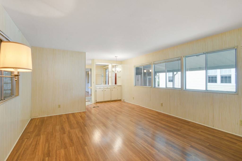 A room with wooden floors and a lamp.